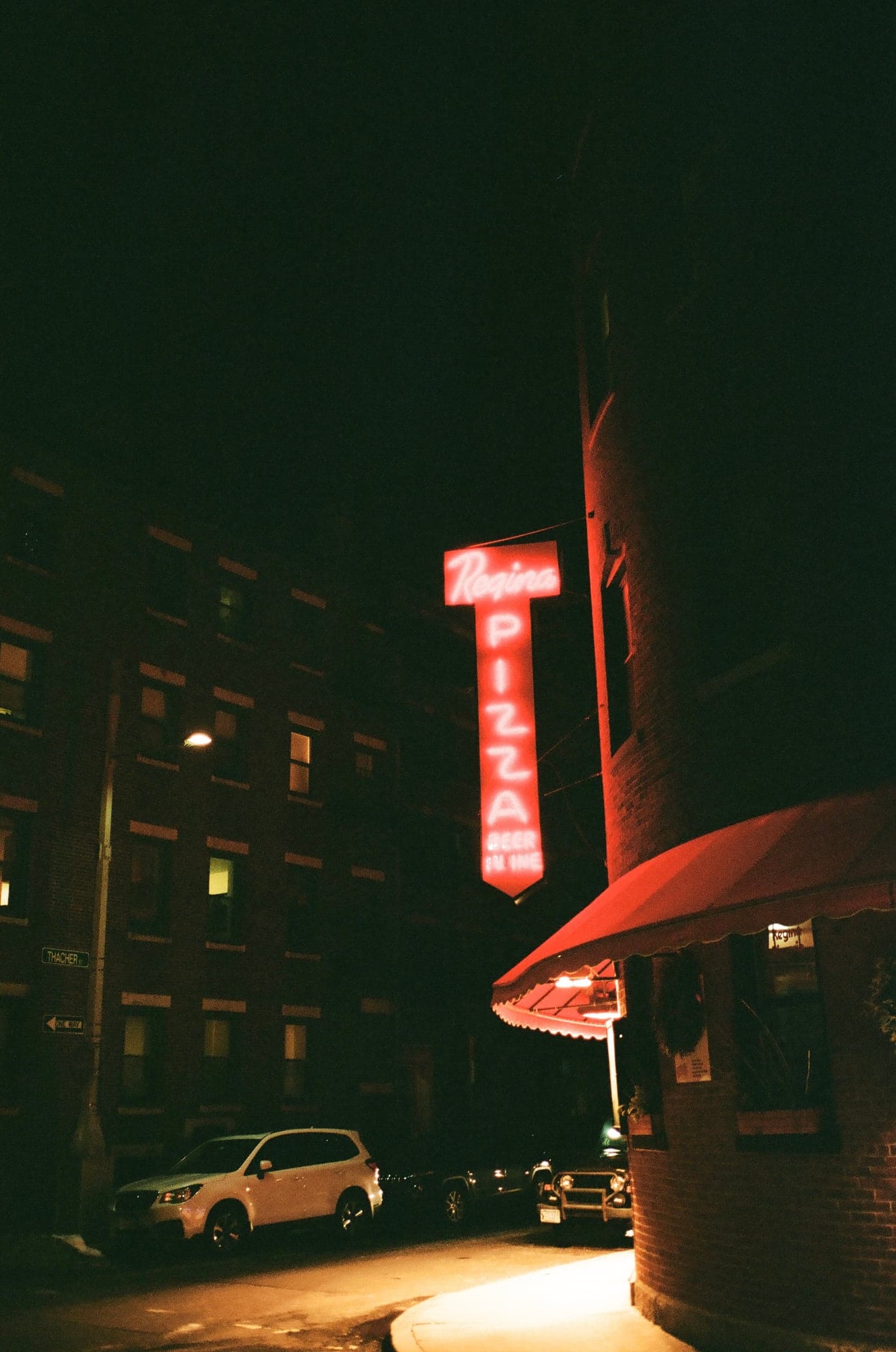 Regina pizzeria neon sign at night